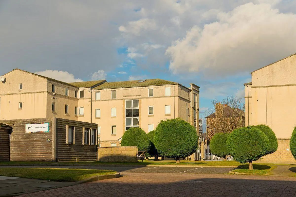 Student accommodation buildings with trees and sky exterior at Trinity Court in Aberdeen Student Accommodation