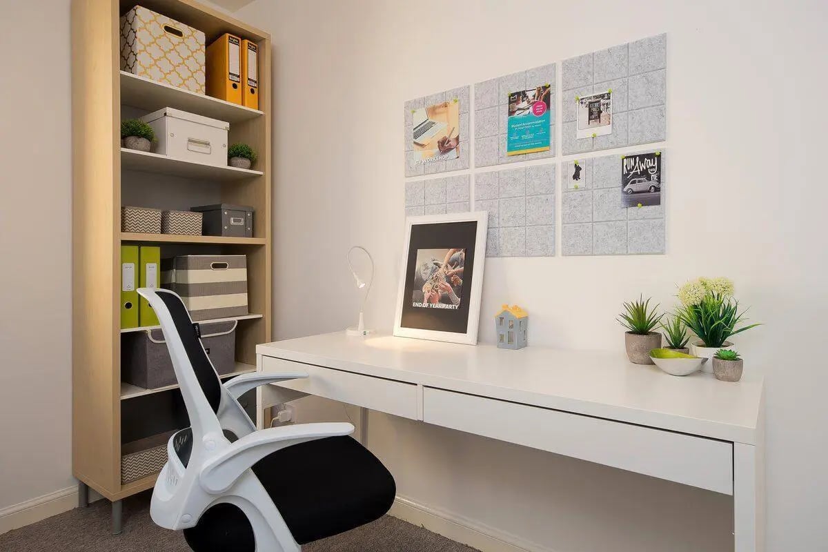 Desk with chair shelving plants and framed art study area at Trinity Court in Aberdeen Student Accommodation