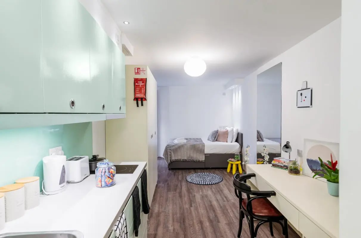 Kitchenette bed study desk large mirror studio at The Stay Club - Camden in London Student Accommodation