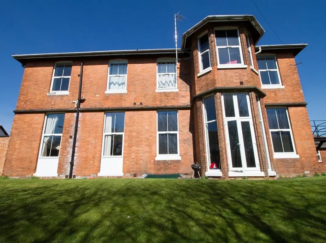 Brick building with large windows lawn exterior at Radmoor House in Loughborough Student Accommodation
