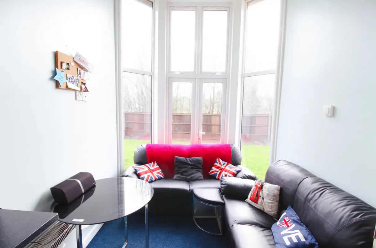 Black sectional sofa union jack pillows living room at Radmoor House in Loughborough Student Accommodation