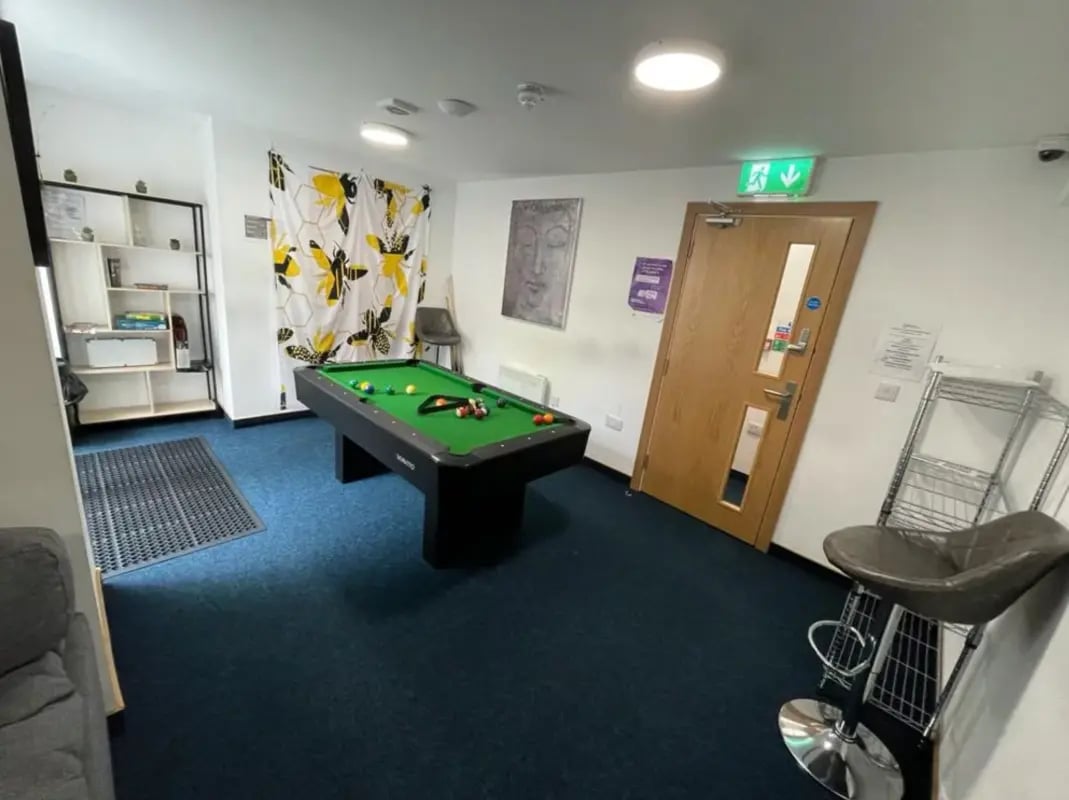 Pool table shelves stool and door Common room at Salisbury Road in Leicester Student Accommodation