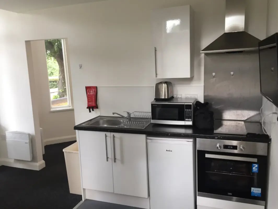 Sink microwave oven toaster cabinets kitchen at Regent Road in Leicester Student Accommodation