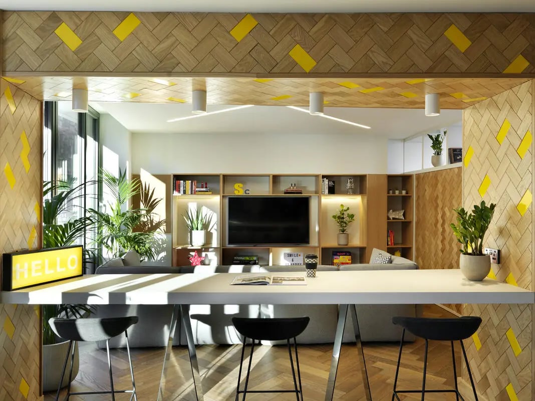 Hello sign plants TV and stools living room at Student Castle Edinburgh in Edinburgh Student Accommodation