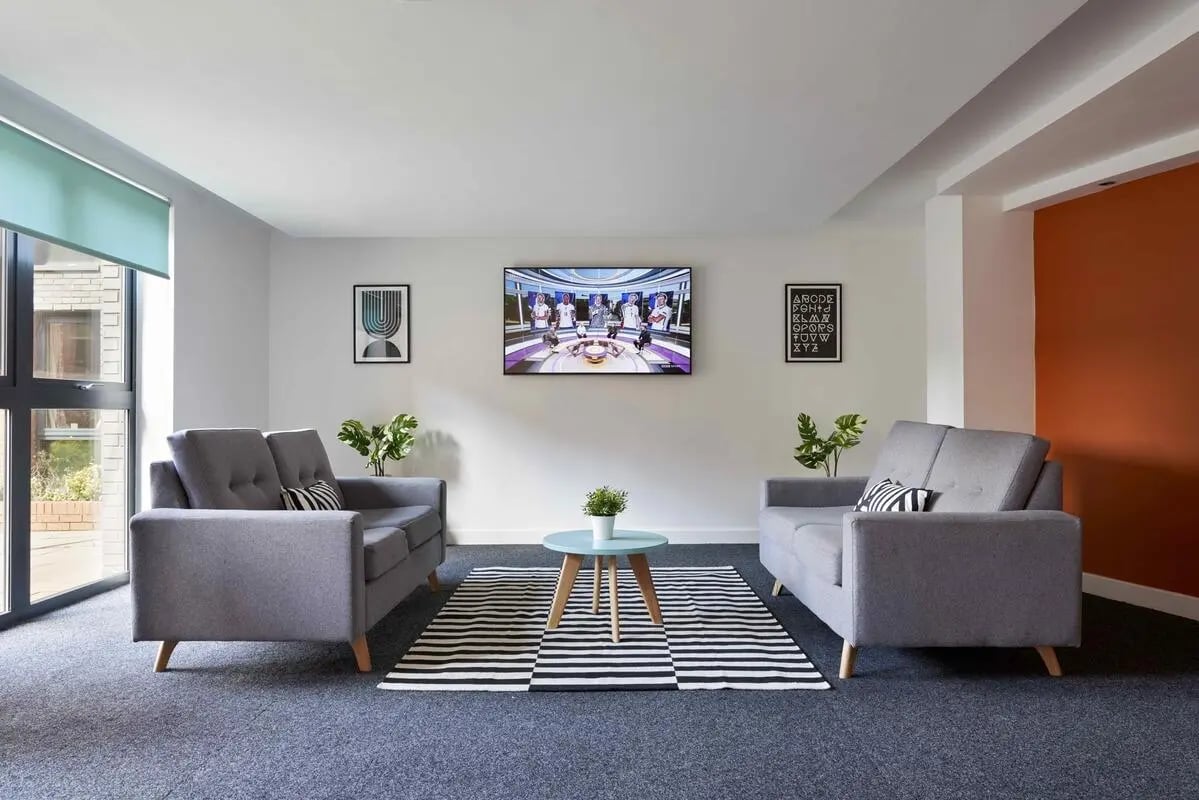Two grey sofas television and coffee table Living room at Central Quay in Sheffield Student Accommodation
