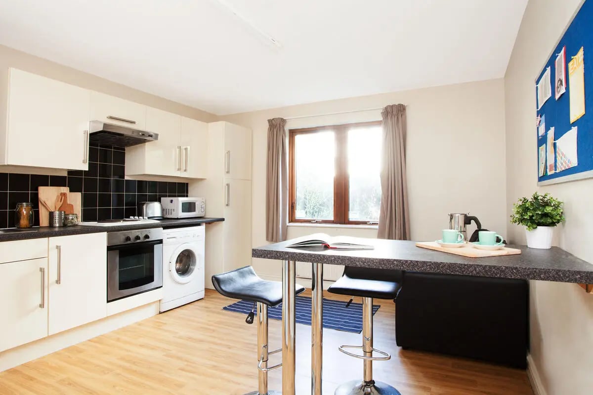 Kitchen with cabinets oven microwave washer bar stools kitchen at Sunlight Apartments in London Student Accommodation