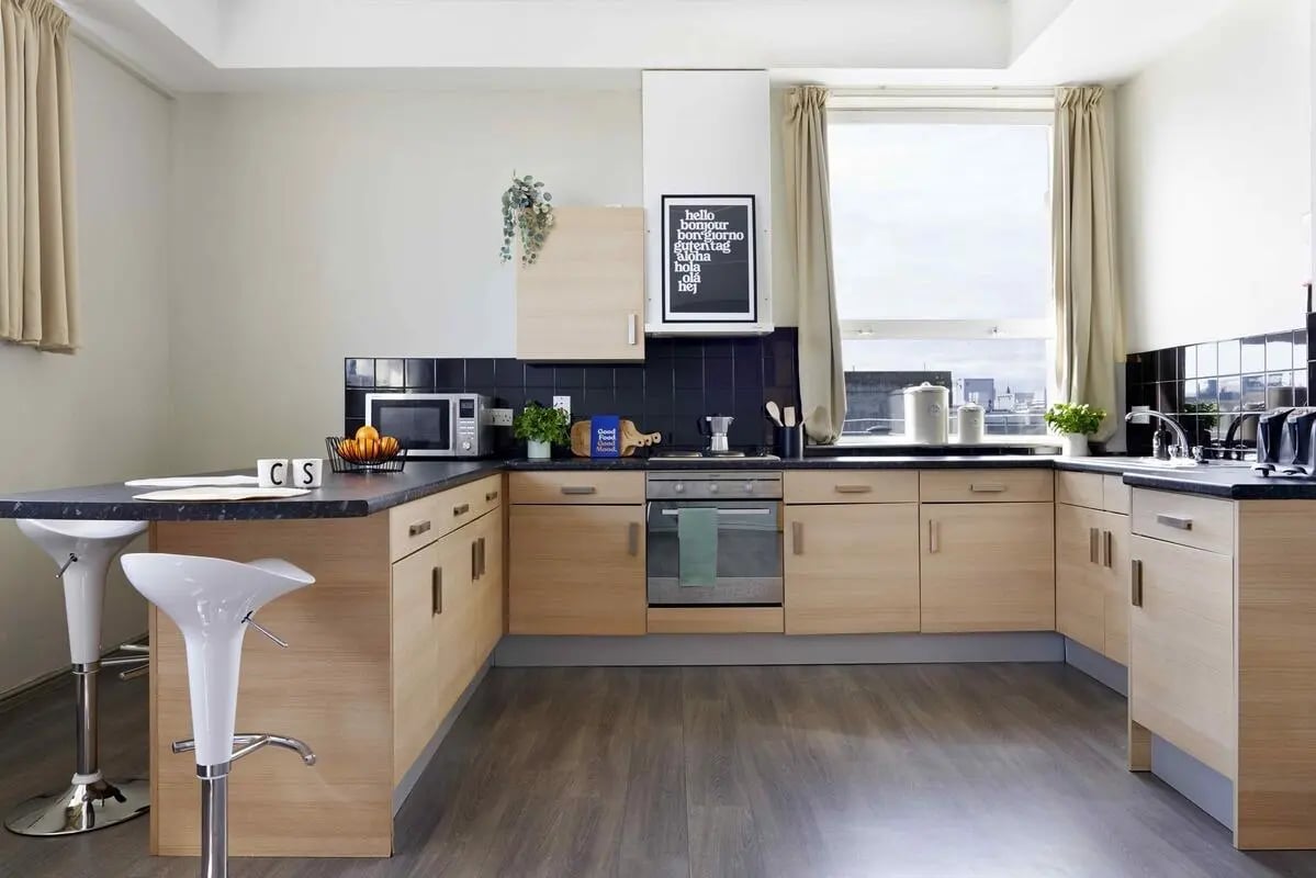 Modern student kitchen with breakfast bar and stools kitchen at Central Point in Plymouth Student Accommodation