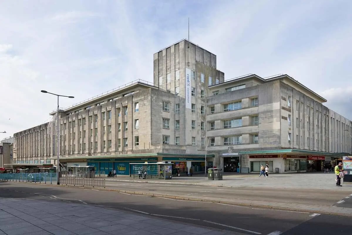 Concrete building with shops on ground floor exterior at Central Point in Plymouth Student Accommodation