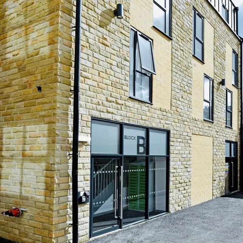 Block B entrance with stairs and windows Exterior at The Courtyard Block B in Huddersfield Student Accommodation