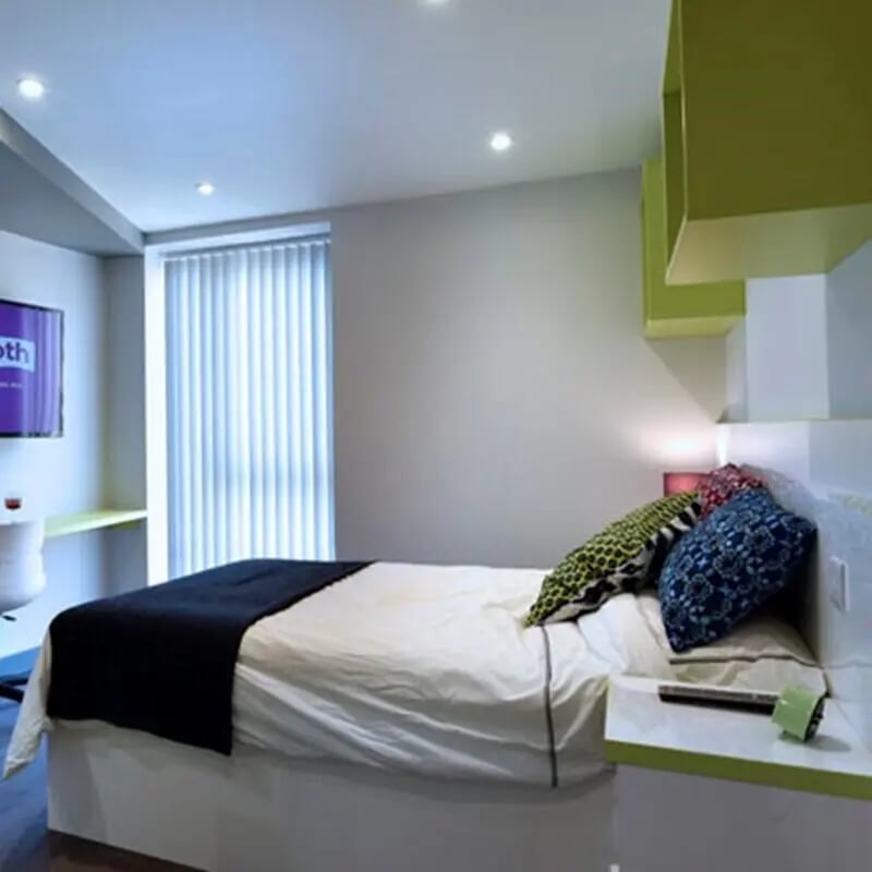 Bed with pillows TV and desk Bedroom at The Courtyard Block B in Huddersfield Student Accommodation