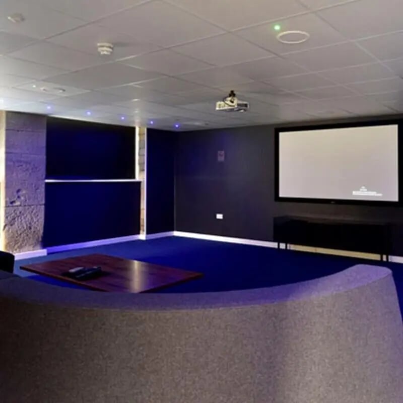 Projector screen coffee table curved seating playing area at The Courtyard Block B in Huddersfield Student Accommodation