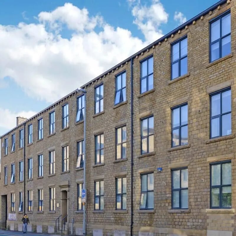 Brick building with many windows exterior at The Courtyard Block C in Huddersfield Student Accommodation