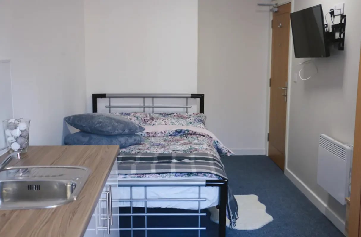Bed with pillows sink on counter bedroom at Renaissance House in Leicester Student Accommodation