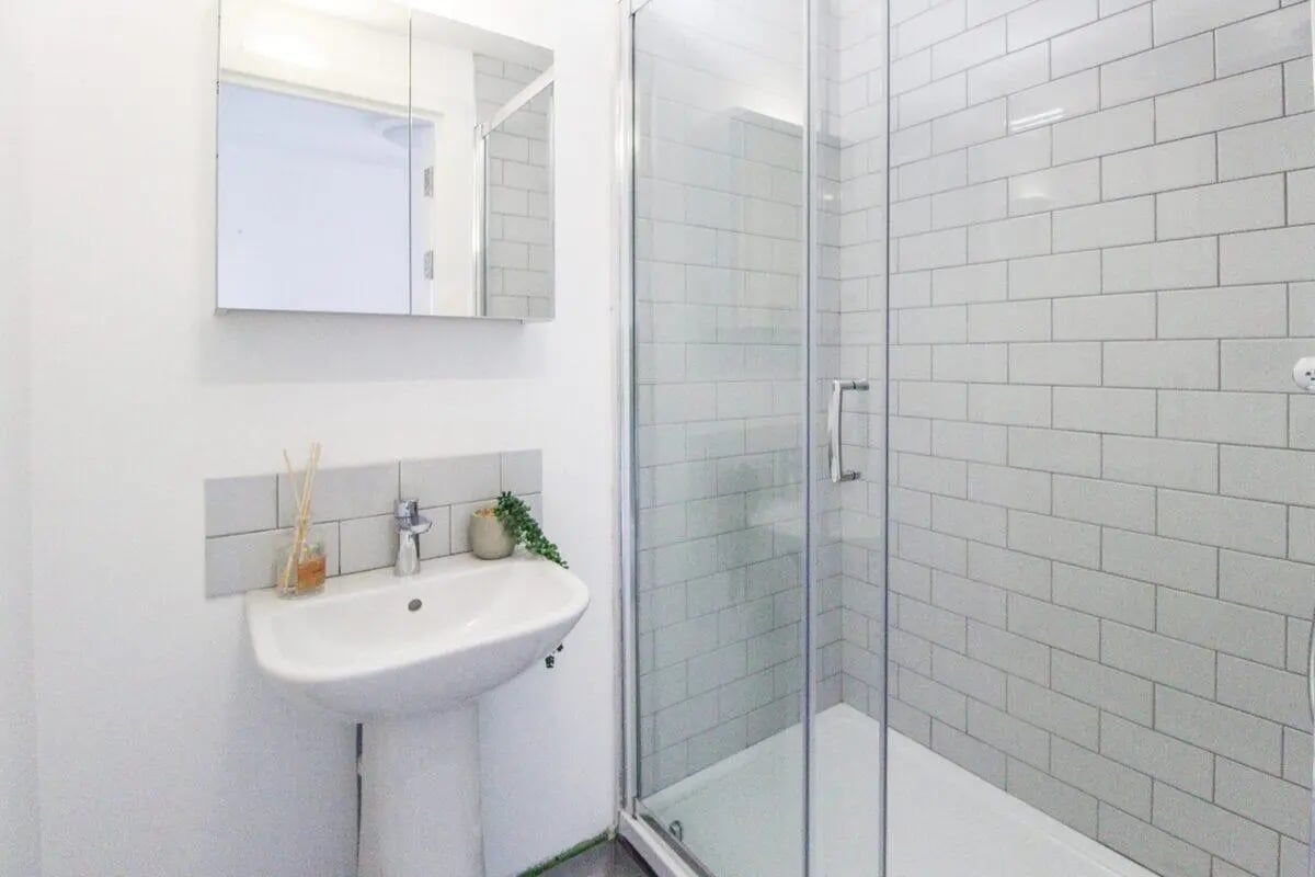 Sink mirror reed diffuser and shower enclosure bathroom at The Nest Leicester in Leicester Student Accommodation