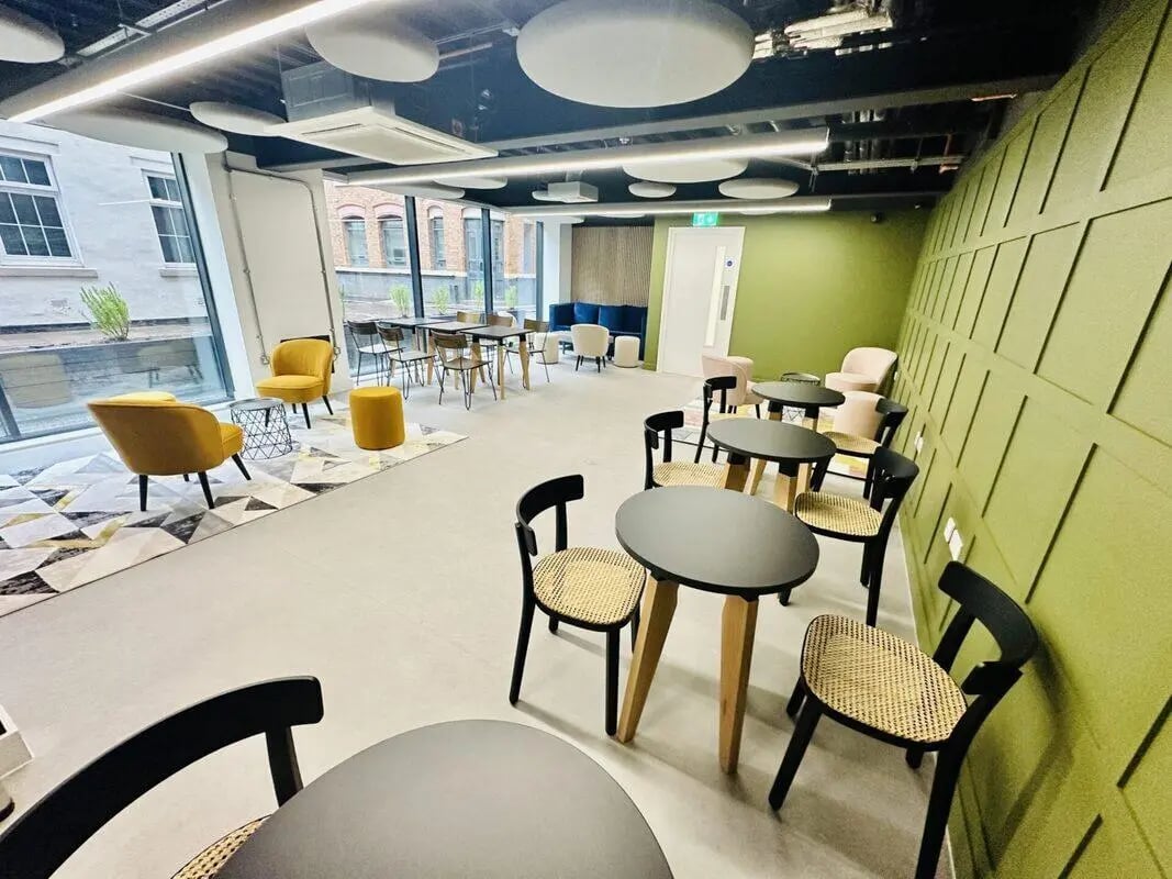 Tables chairs rug modern communal area at The Nest Leicester in Leicester Student Accommodation