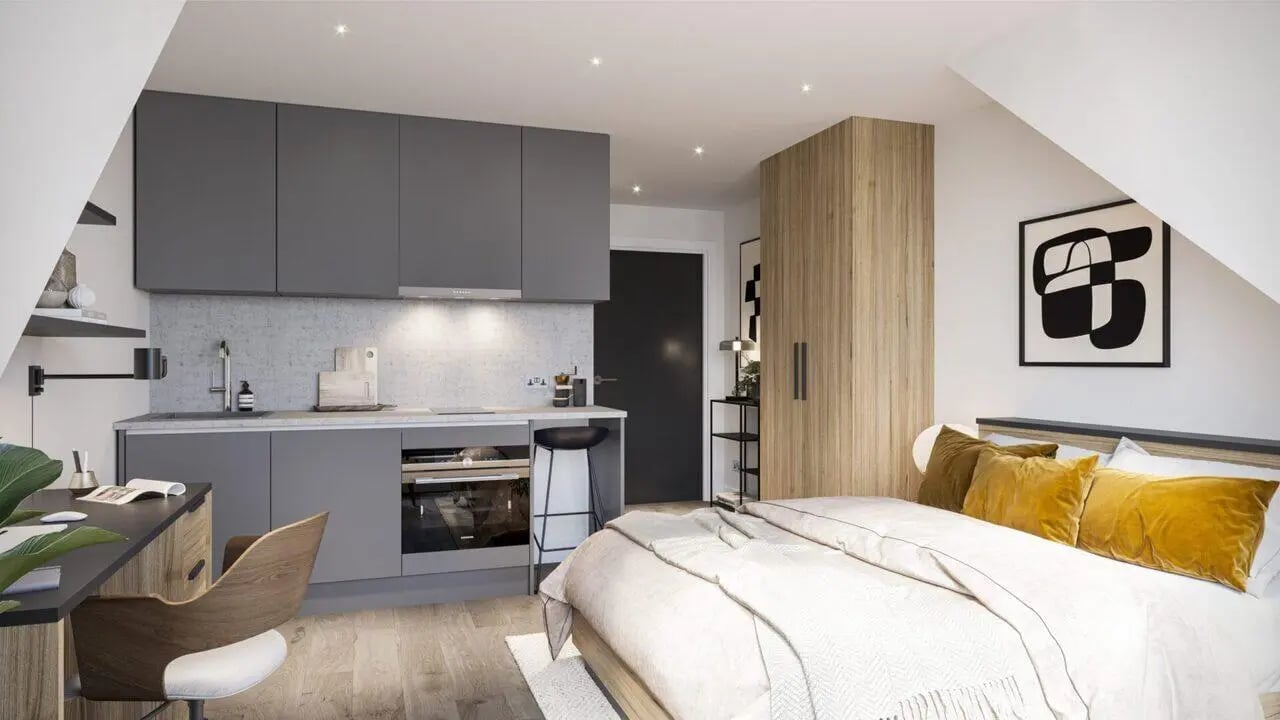 Bed desk kitchen wardrobe and abstract art living room at The Nest Leicester in Leicester Student Accommodation