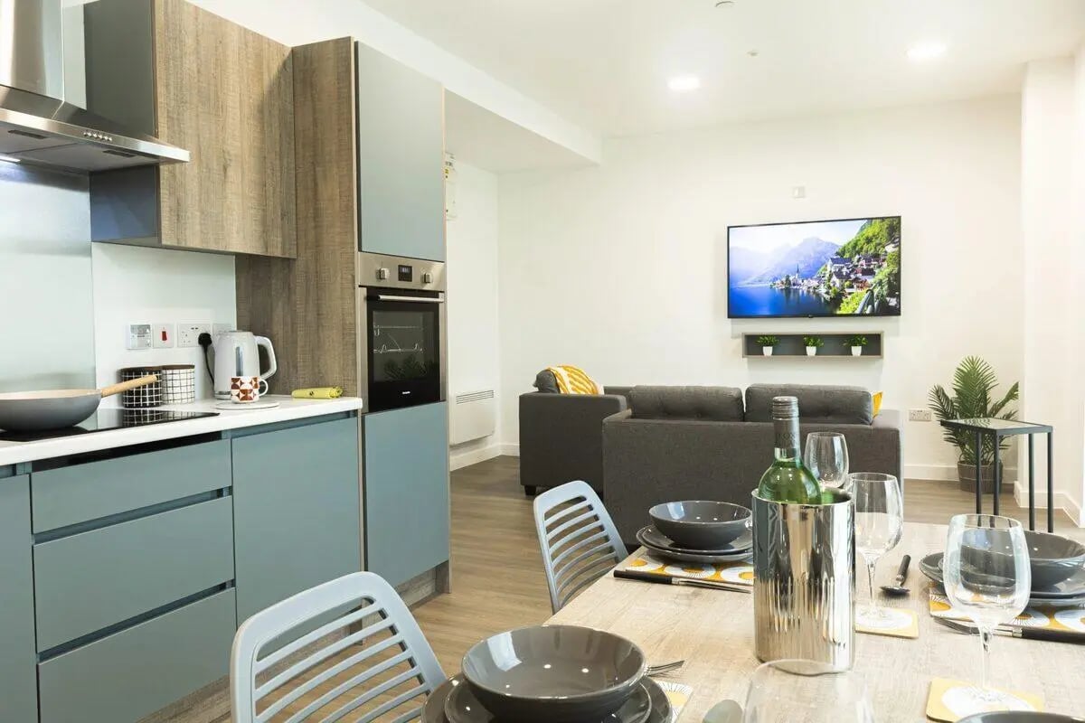 Kitchen and living area with grey sofa living room at Albany Student Village in Coventry Student Accommodation
