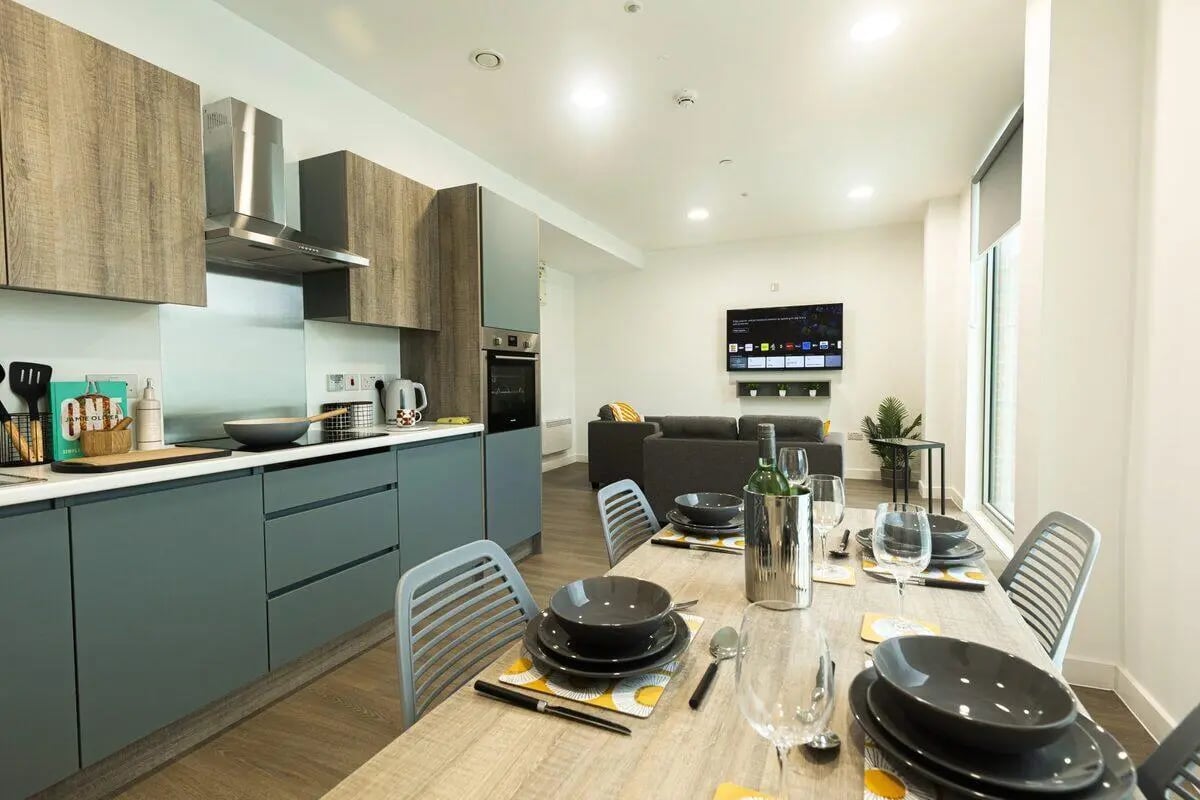 Kitchen and living area with table setting living room at Albany Student Village in Coventry Student Accommodation