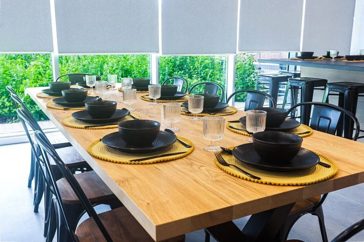 Dining table set with black plates and glasses dining area at Albany Student Village in Coventry Student Accommodation