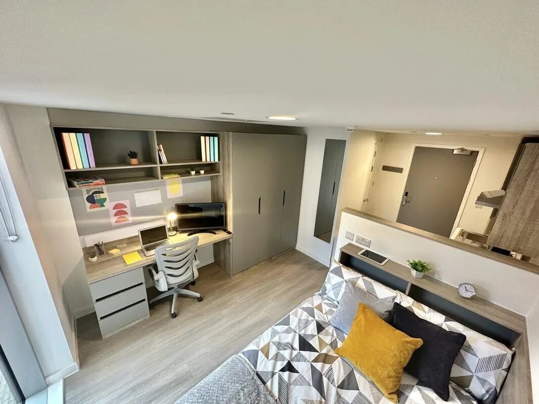 Desk computer chair shelves and bed bedroom at Albany Student Village in Coventry Student Accommodation