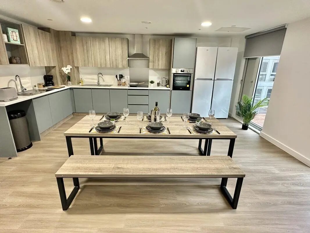 Dining table and benches with place settings kitchen living room at Albany Student Village in Coventry Student Accommodation