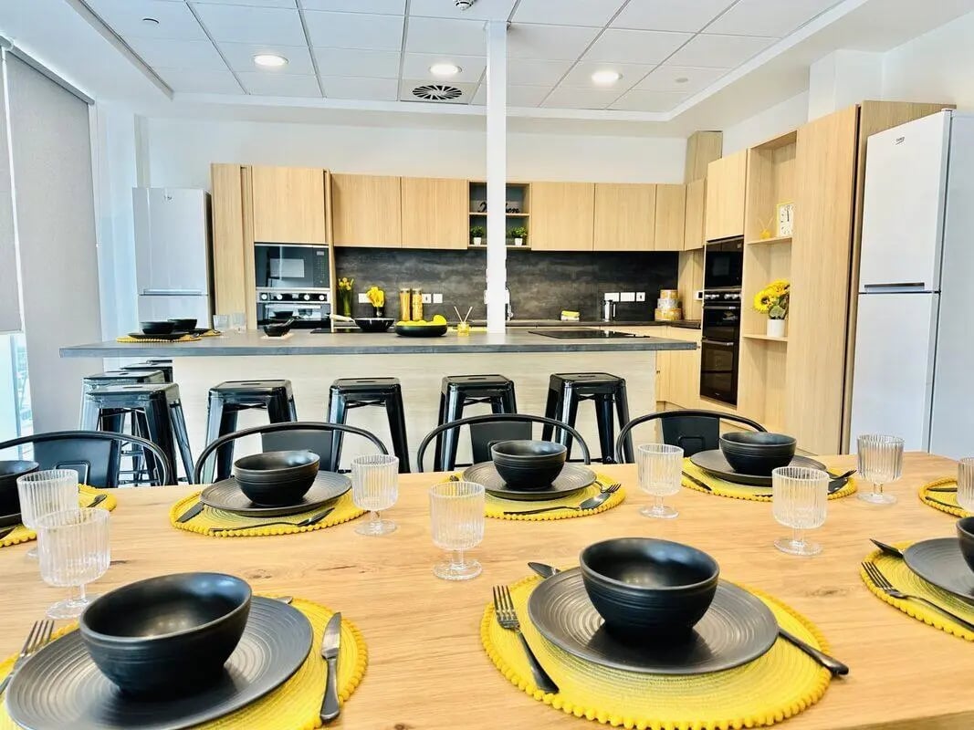 Table setting with bowls glasses and kitchen dining area at Albany Student Village in Coventry Student Accommodation