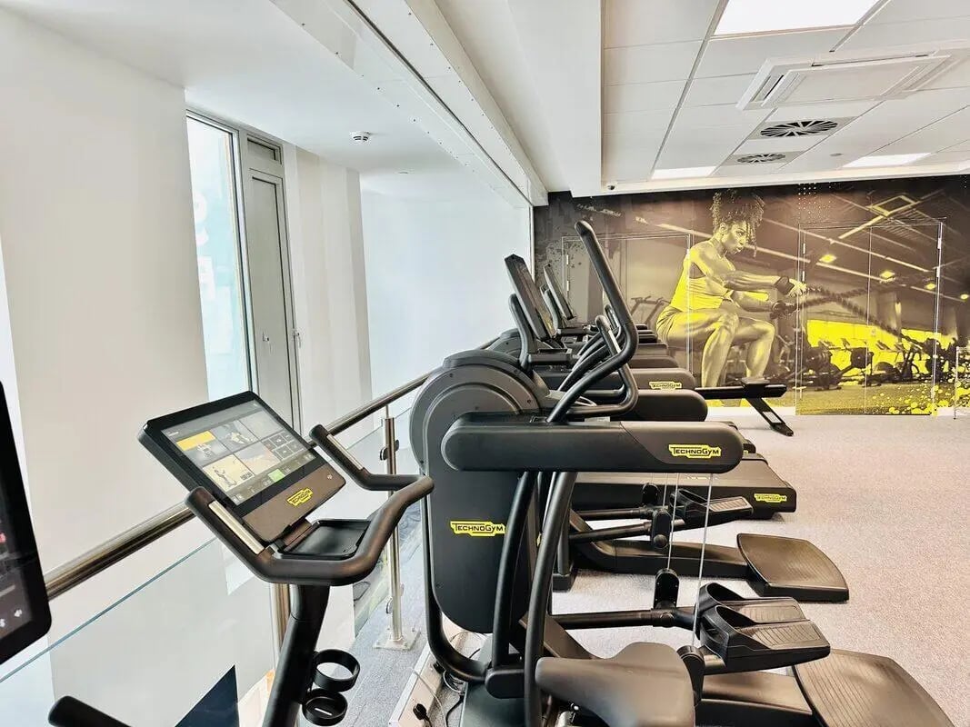 Exercise machines with screen gym playing area at Albany Student Village in Coventry Student Accommodation