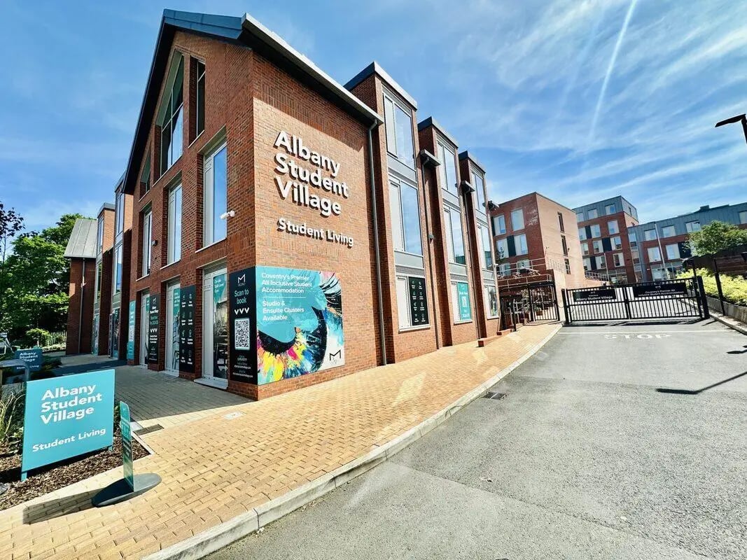 Brick building entrance with signage exterior. at Albany Student Village in Coventry Student Accommodation