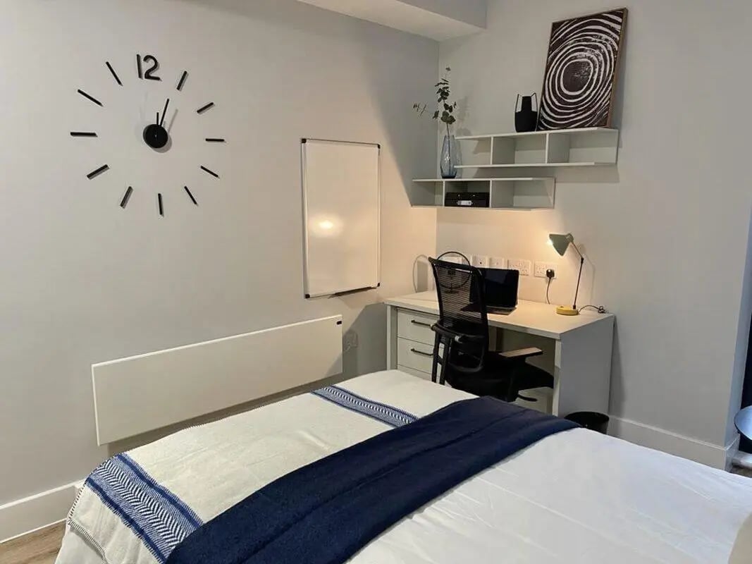 Bed whiteboard desk chair laptop artwork Bedroom at Hydrogen Falmouth in Falmouth Student Accommodation