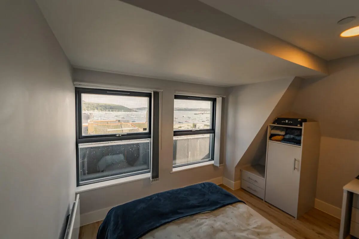 Bed wardrobe and sea view bedroom at Hydrogen Falmouth in Falmouth Student Accommodation