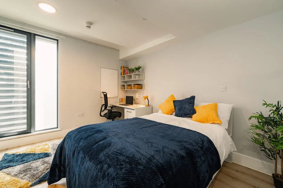 Bed desk chair whiteboard shelves bedroom at Hydrogen Falmouth in Falmouth Student Accommodation