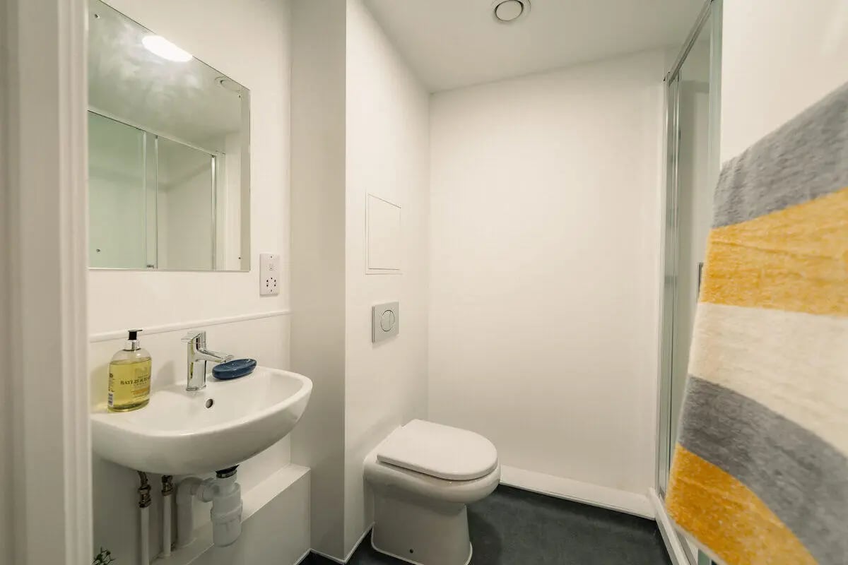 Sink toilet shower and towel bathroom at Hydrogen Falmouth in Falmouth Student Accommodation