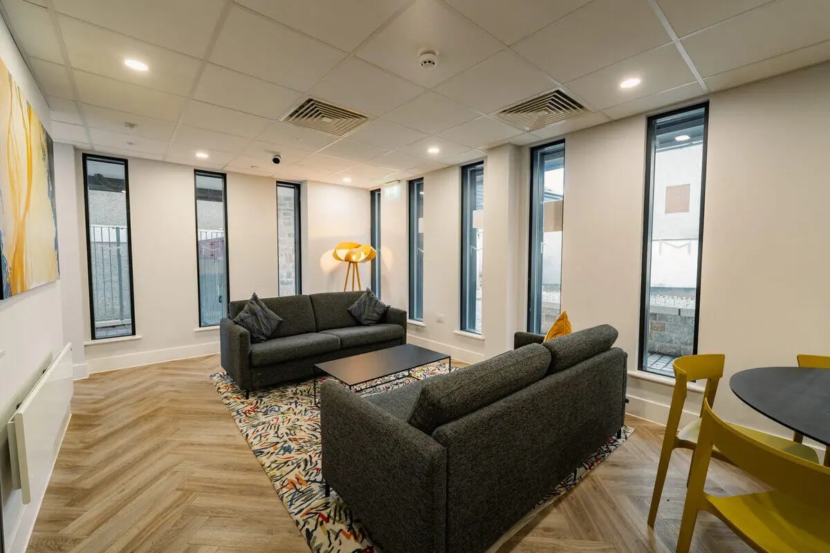 Two grey sofas coffee table with abstract rug living room at Hydrogen Falmouth in Falmouth Student Accommodation