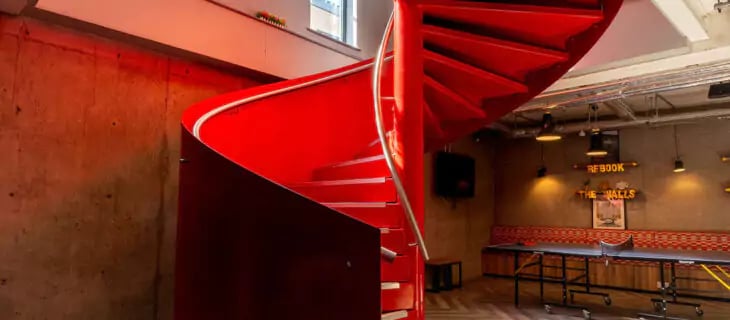 Red spiral staircase ping pong table common area at The Walls in Southampton Student Accommodation