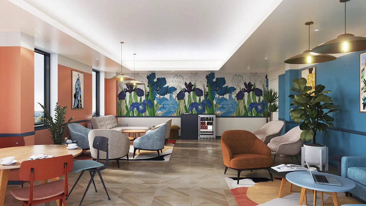 Sofa chairs tables floral mural communal area living room at B16 Studios in Birmingham Student Accommodation