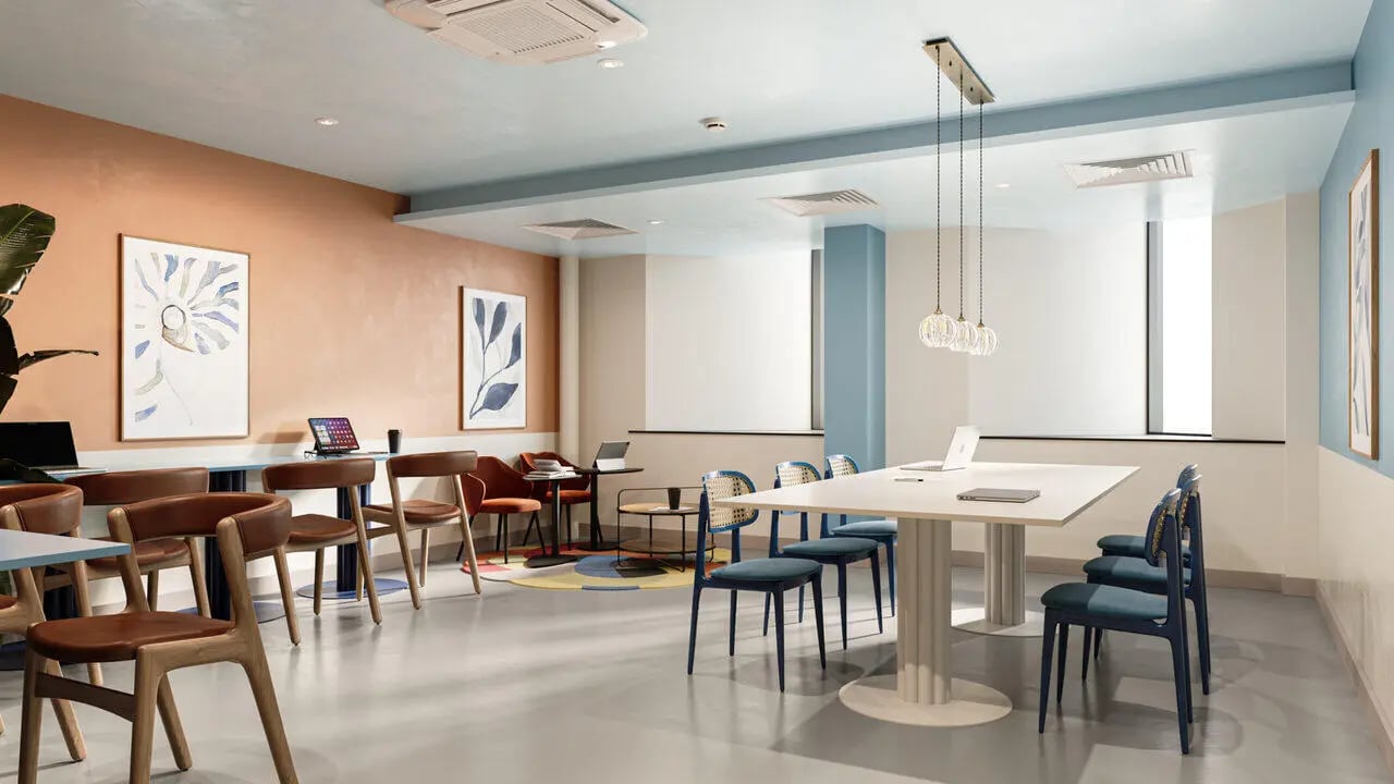 Modern communal area with tables chairs and laptops lounge at B16 Studios in Birmingham Student Accommodation