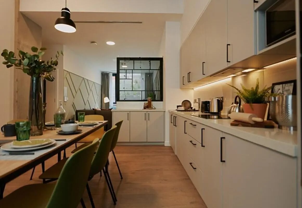 Dining table kitchen with cabinets appliances kitchen at The Loom in Dublin Student Accommodation