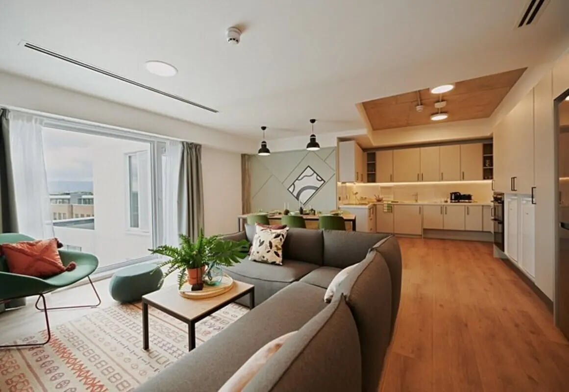 Sofa dining table and kitchen living room at The Loom in Dublin Student Accommodation