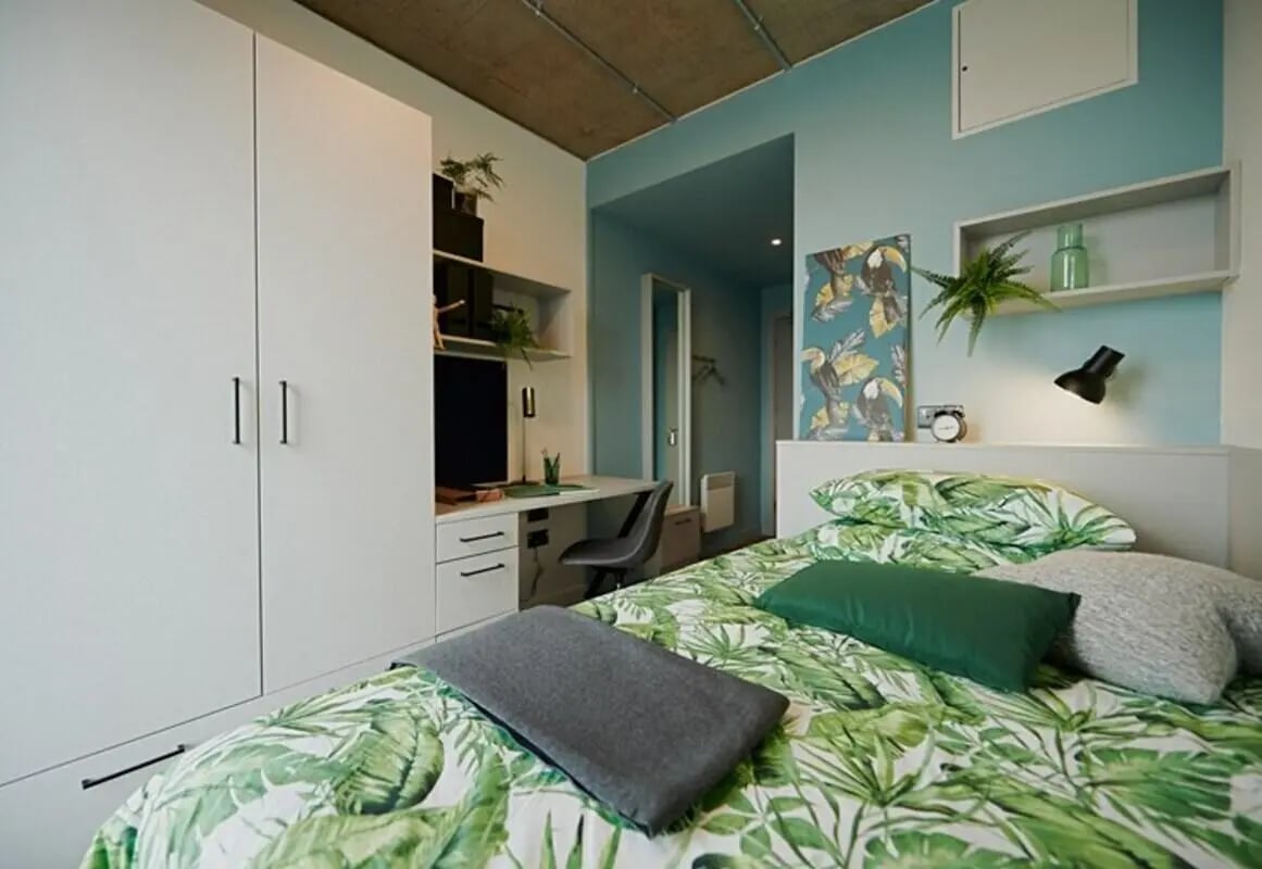 Wardrobe desk bed with tropical print bedding bedroom at The Loom in Dublin Student Accommodation