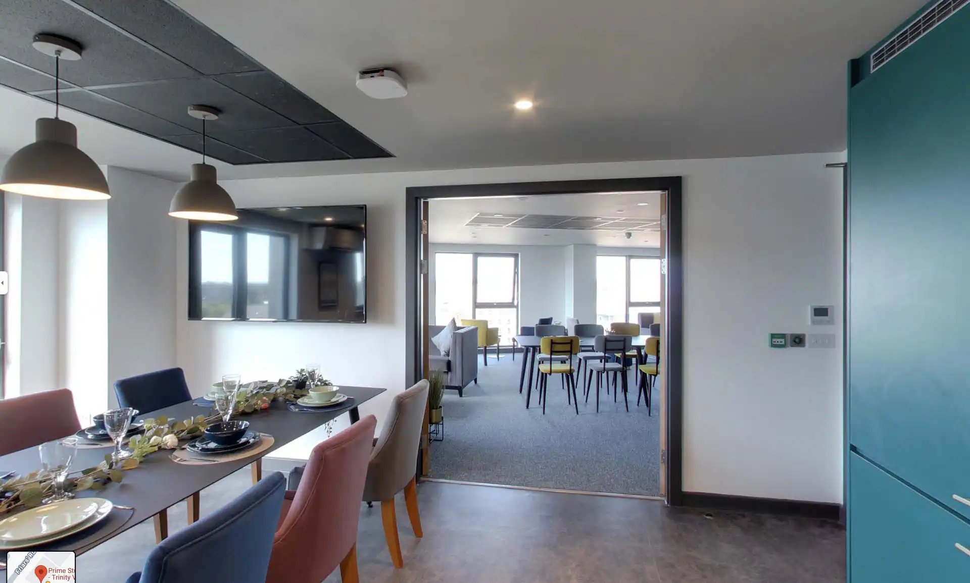Dining table with place settings and chairs living room. at Trinity View Coventry in Coventry Student Accommodation