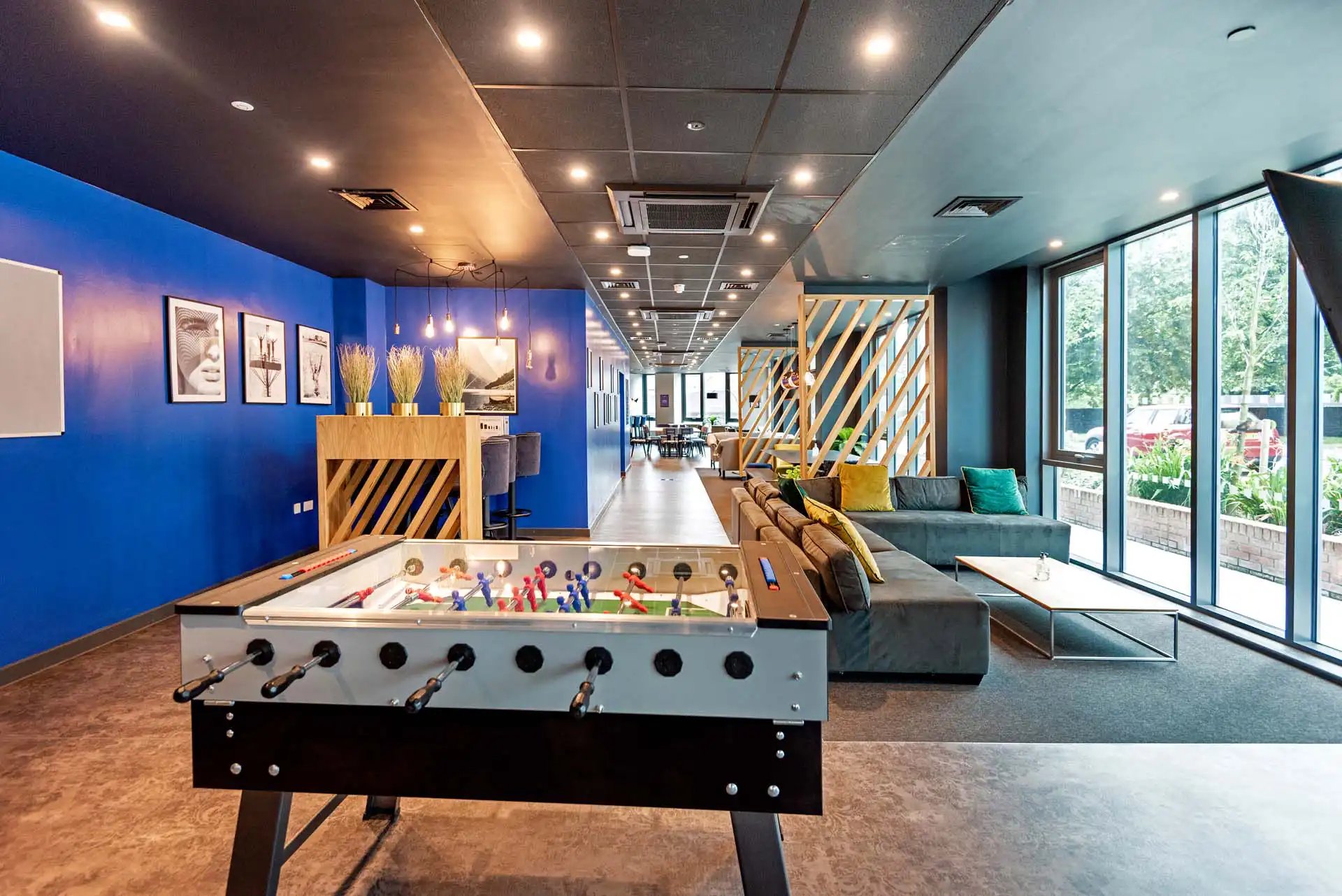 Foosball table and sofa in common area. at Trinity View Coventry in Coventry Student Accommodation