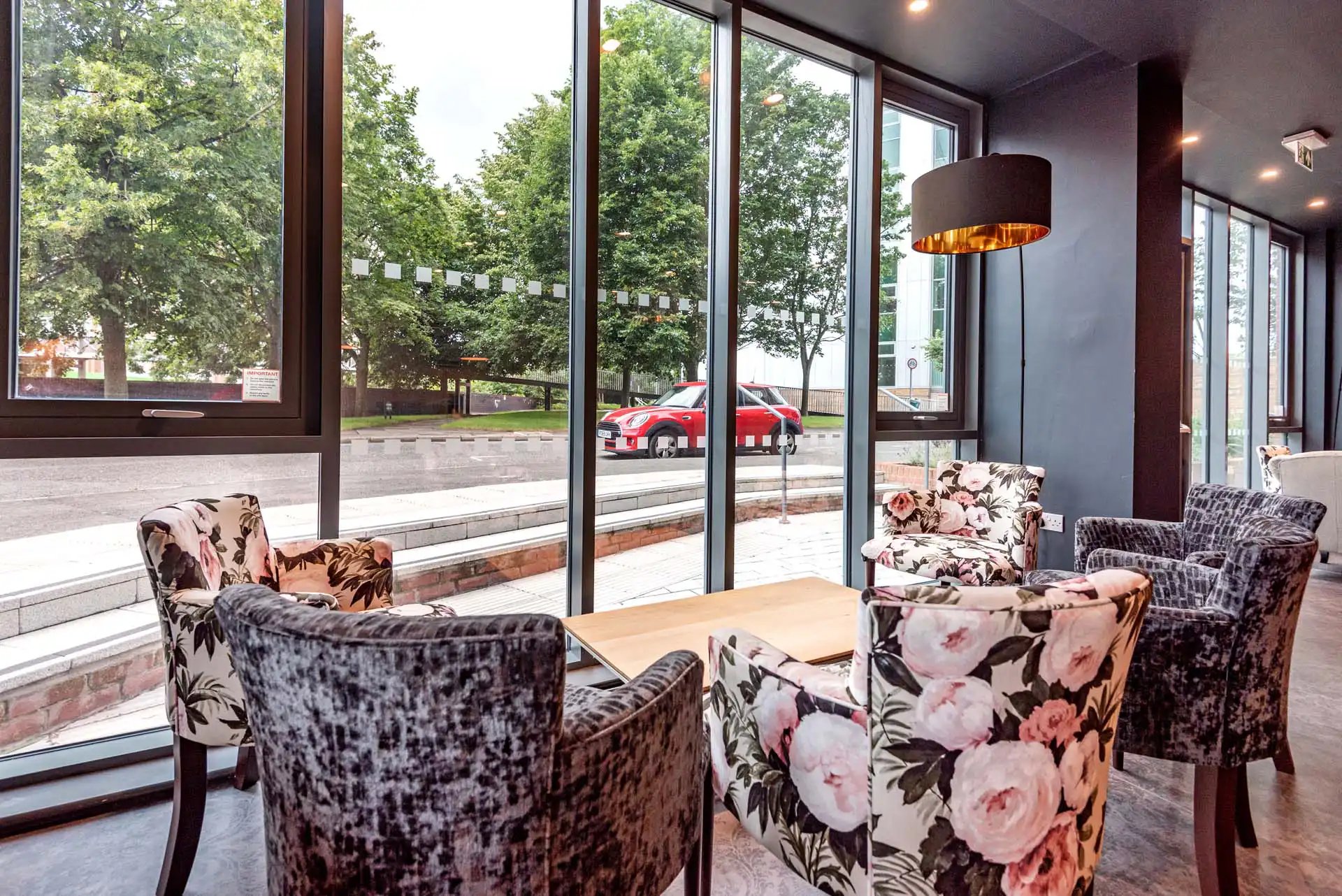 Chairs and table with floral pattern living room at Trinity View Coventry in Coventry Student Accommodation