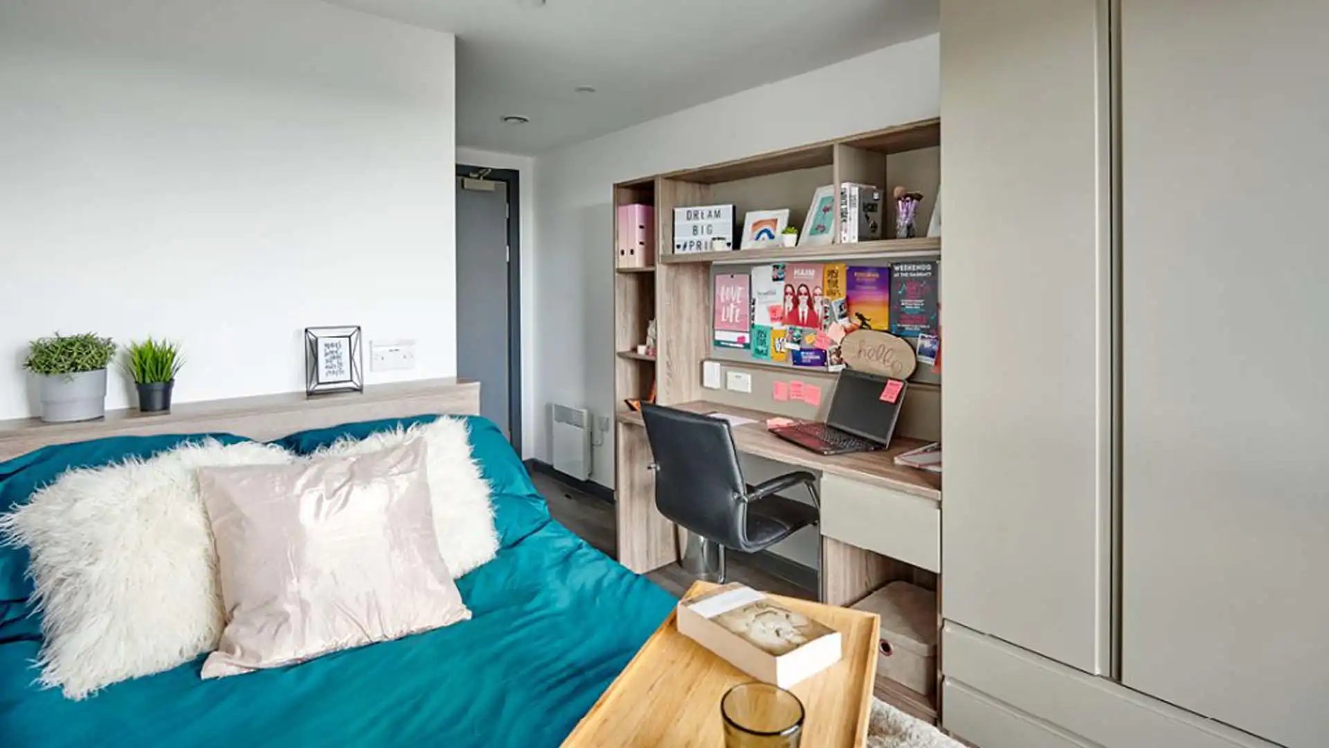 Bed with pillows desk and laptop bedroom at Trinity View Coventry in Coventry Student Accommodation