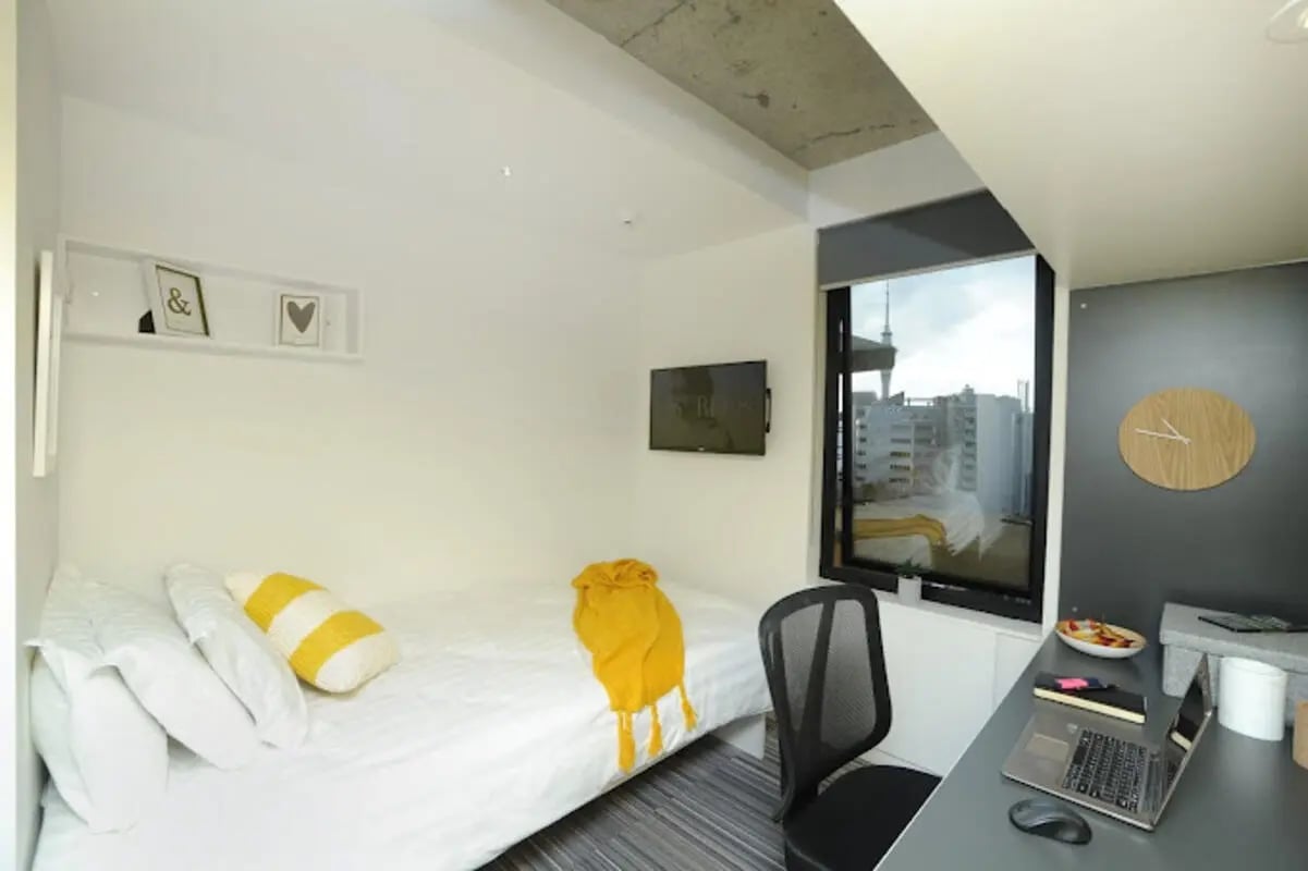 Bed desk chair clock and TV bedroom study area at UniLodge Auckland City in Auckland Student Accommodation