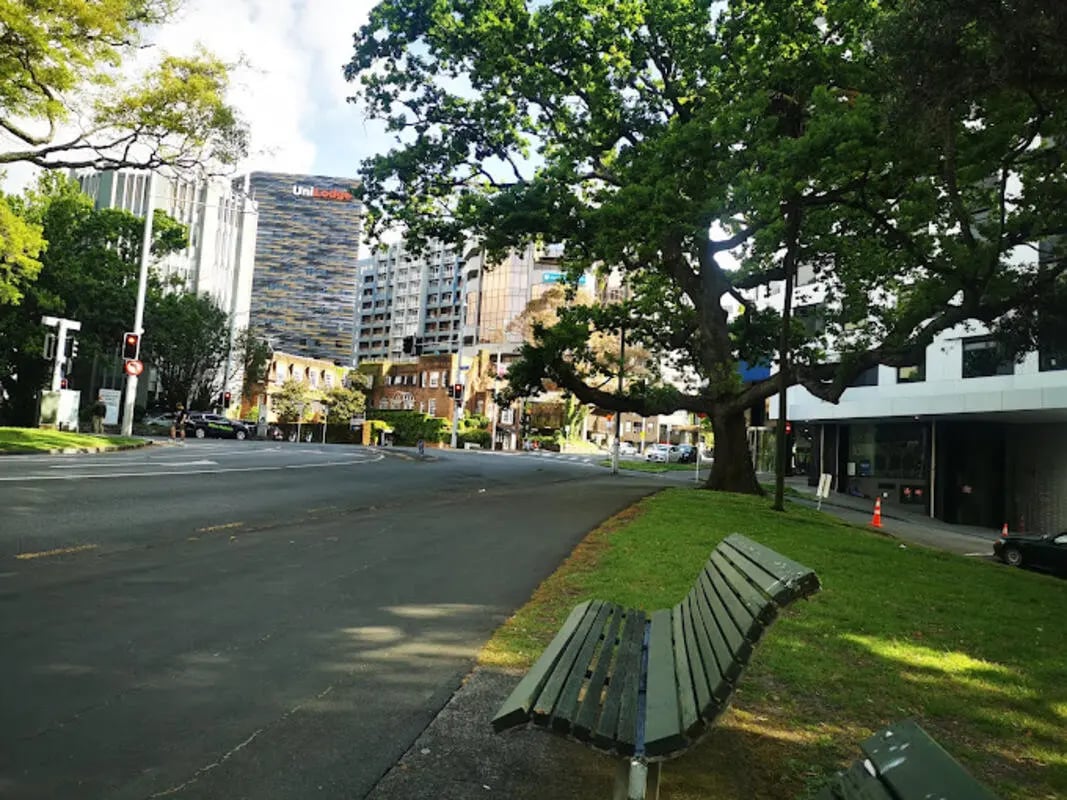 Bench on grassy area beside road exterior at UniLodge Auckland City in Auckland Student Accommodation