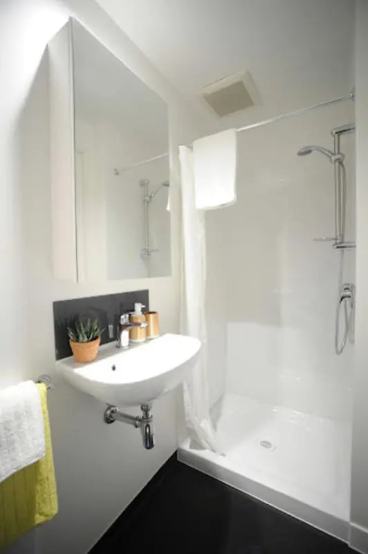 White sink shower towels with plant bathroom at UniLodge Auckland City in Auckland Student Accommodation
