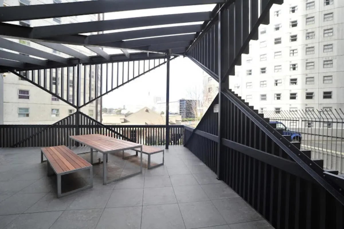 Tables and benches on tiled patio exterior at UniLodge Auckland City in Auckland Student Accommodation