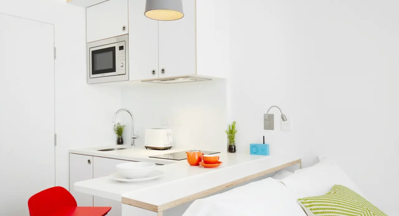 Kitchenette with microwave sink toaster and breakfast bar kitchen at Scape Abercrombie in Sydney Student Accommodation