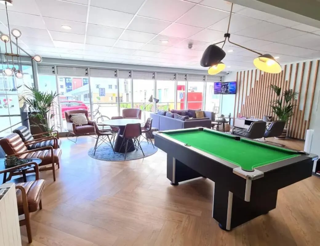 Pool table lounge area with seating and plants at Buchanan View in Glasgow Student Accommodation