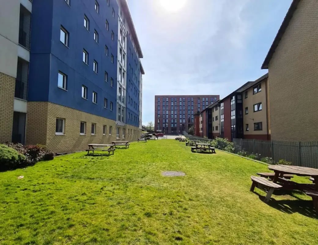 Picnic tables on grassy lawn exterior at Buchanan View in Glasgow Student Accommodation